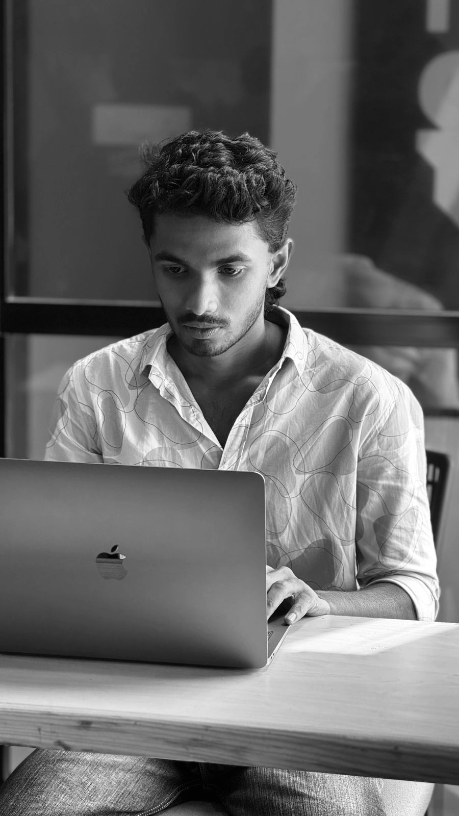 Person working on a laptop in a dimly lit room freelance digital marketer in Kochi.